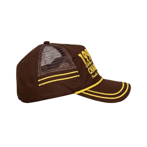 Side view of Duvin 94 Hat in Brown showing a curved brim, breathable fabric, and classic snapback silhouette