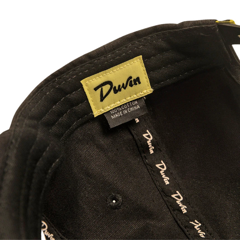 Black Duvin Tropical Oasis Hat laid flat to showcase tropical patch and hat structure