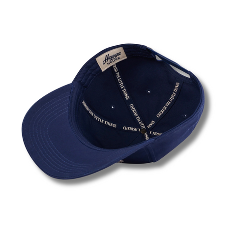 Flat lay of Huega House Athletic Association Hat in Navy highlighting front embroidered logo, curved brim, and structured design