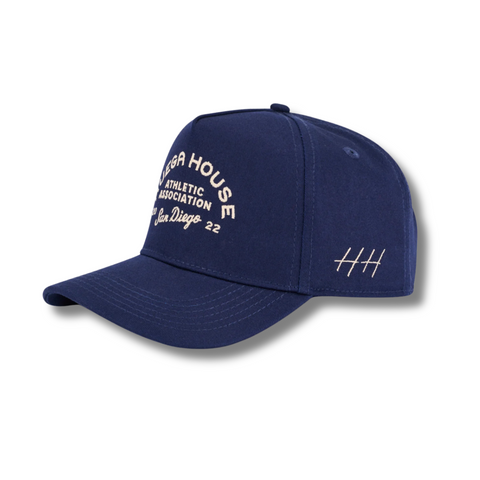 Side view of Huega House Athletic Association Hat in Navy showing curved brim, mid-profile fit, and clean classic styling