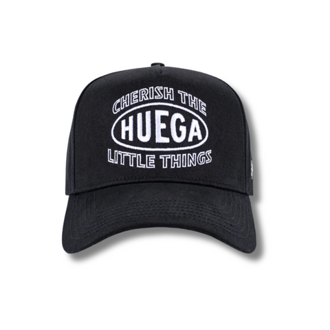 Front view of Huega House Circuit Hat in Black featuring minimalist tonal logo embroidery on a structured crown with a flat brim