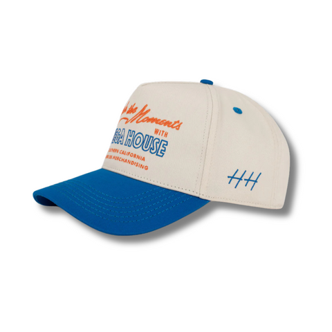 Side view of Huega House Moments Hat in Blue/Natural showing contrast brim, breathable panel design, and mid-profile fit