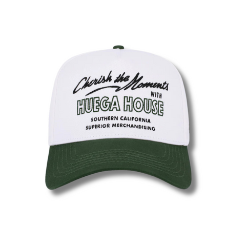 Front view of Huega House Moments Hat in Pine Green and White featuring embroidered “Moments” text on a structured pine green crown with a white curved brim