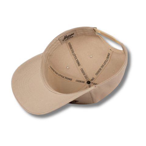Flat lay of Huega House Trademark Hat in Khaki showcasing front logo detail, smooth construction, and neutral tone