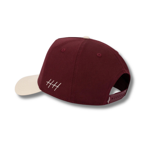 Back view of Huega House Trademark Hat in Natural and Maroon with adjustable strap and clean two-tone color blocking