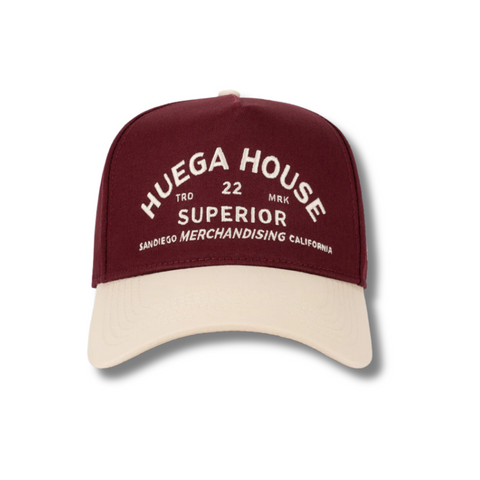 Front view of Huega House Trademark Hat in Natural and Maroon featuring the Huega House logo embroidered on a structured crown with a contrast maroon brim