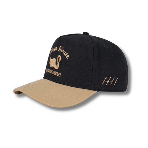 Side view of Huega House Vintage Swan Hat in Black/Khaki showing the clean side panel design, curved brim, and classic trucker silhouette