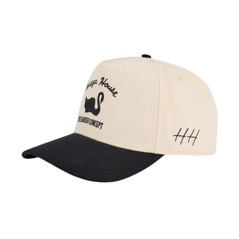 Side view of Huega House Vintage Swan Hat in Black/Natural showing two-tone color design, curved brim, and classic trucker style