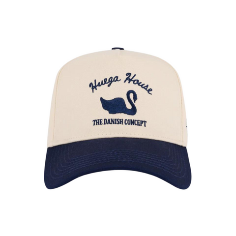 Front view of Huega House Vintage Swan Hat in Navy and Natural featuring a vintage-style swan patch on a structured navy crown with a contrasting natural brim