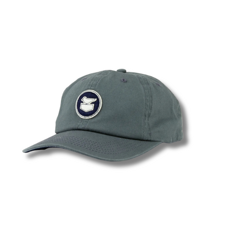 Side view of Jetty Throwback Hat in slate showing curved brim, breathable mesh back, and retro silhouette