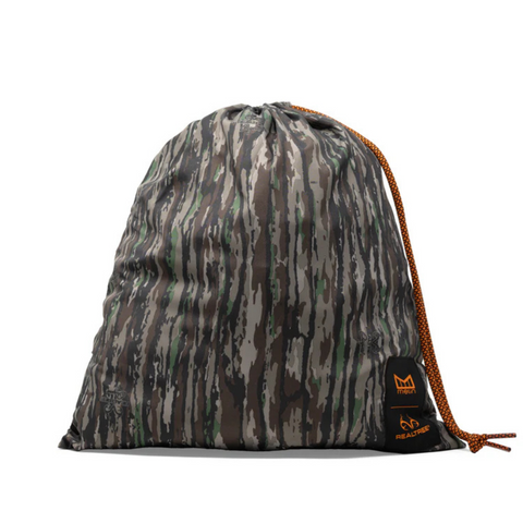 Close-up of Real Tree camo pattern, logo patch, and waterproof fabric on the Melin Coronado Hydro in Edge