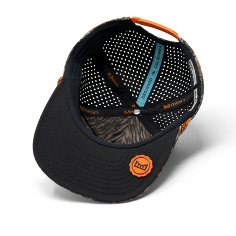 Flat lay of Melin Coronado Real Tree Hydro in Edge highlighting camo print, laser-perforated panels, and technical build