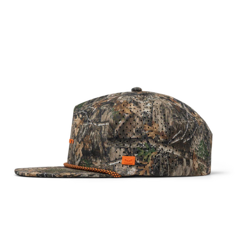 Side view of Melin Coronado Real Tree Hydro in Edge showing camo print, curved brim, and water-resistant panels