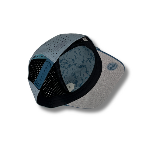 Flat lay of Melin Hydro Odyssey Rope Bulls Icon Hat in Blue Horizon / Pacific Ocean highlighting ocean-tone rope detail and embroidered patch