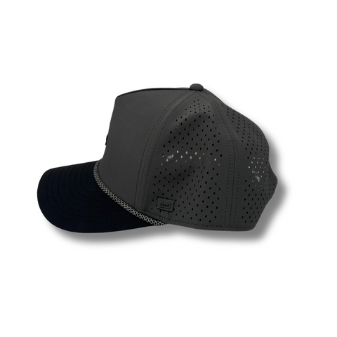 Side view of Melin Hydro Odyssey Rope Bulls Icon Hat in Charcoal/Black showing curved brim, dark breathable panels, and water-resistant fabric