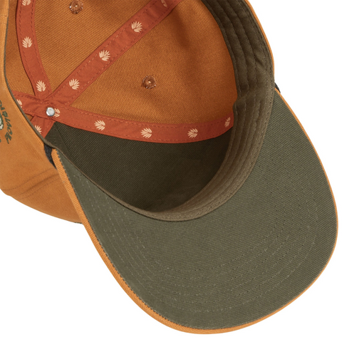 Flat lay of Sendero Bear Hat highlighting the embroidered bear patch, structured front panel, and curved brim