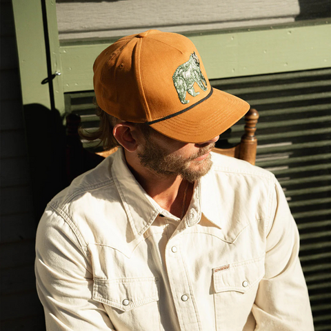 Person wearing the Sendero Bear Hat in an outdoor or adventure-ready setting