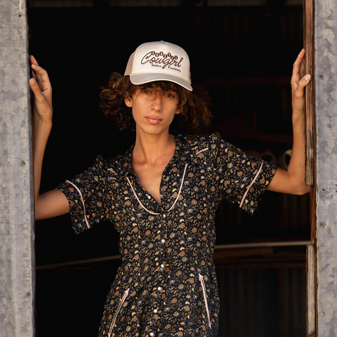 Person wearing the Sendero Coastal Cowgirl Hat in cream and brown in a sunny outdoor, ranch or beach setting
