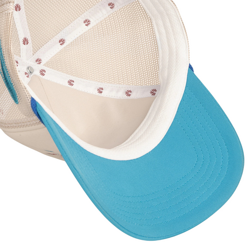 Flat lay of Sendero Coastal Cowgirl Hat in white and blue highlighting front patch, curved brim, and western-inspired aesthetic