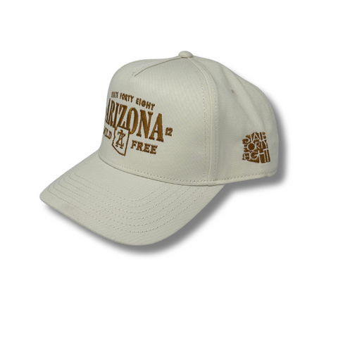 Side angle of the ecru State 48 Wild & Free hat, highlighting the structured fit and curved bill with contrast stitching