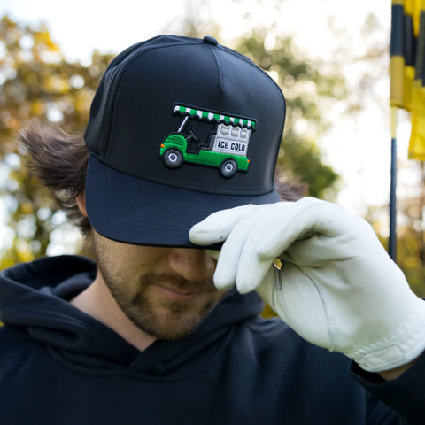 Person wearing the Waggle Bev Cart Hat in a relaxed, fun golf course setting