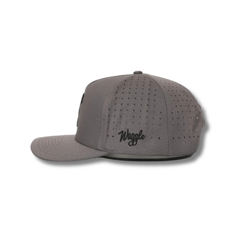 Side view of Waggle Sasquatch Hat in Grey showing curved brim, mid-profile fit, and perforated mesh panels for breathability