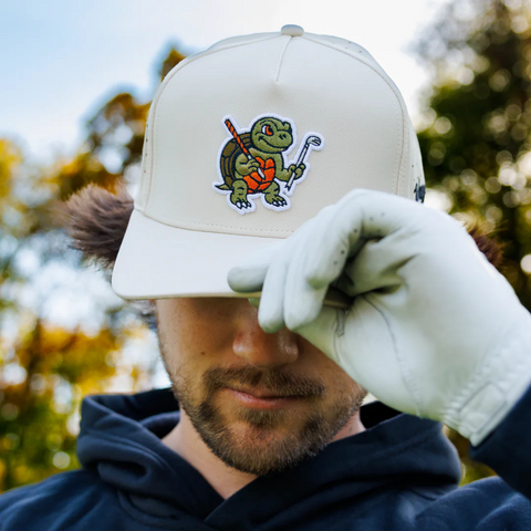 Person wearing the Waggle Snapper Hat on the golf course or at a coastal outing, styled for playful performance
