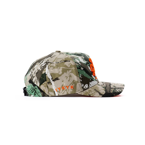 Side view of DadGang DadTree Camo Trucker Hat in Orange showing the curved brim, mesh back, and camo front panel with bold orange contrast