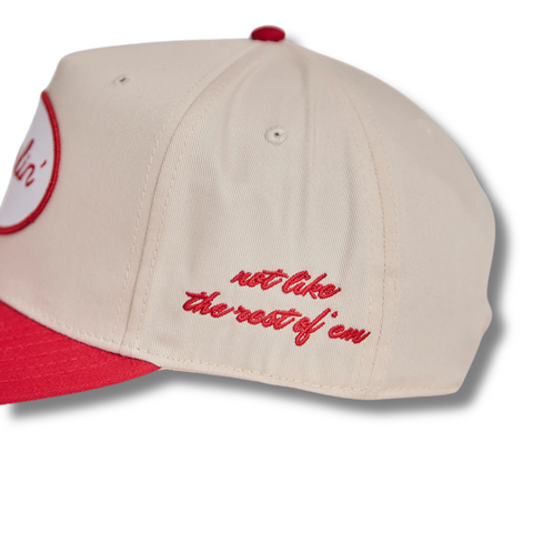 Close-up of the white DARLIN'® patch with red embroidery and curved red brim on the snapback cap