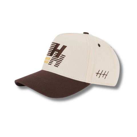 Side view of Huega House Legacy Hat in Brown/Natural showing two-tone design with tonal stitching and mid-profile fit