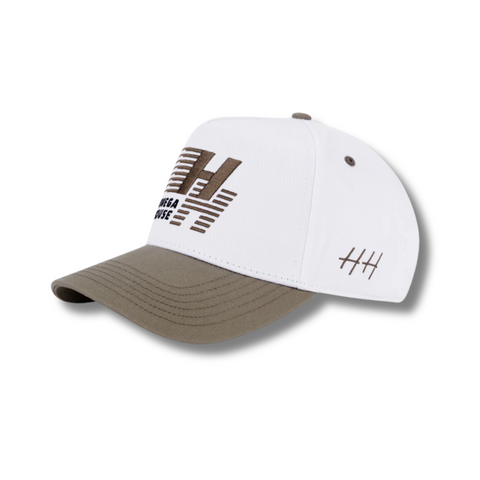 Side view of Huega House Legacy Hat in Cement/White showing contrast brim, mid-profile fit, and breathable cotton construction