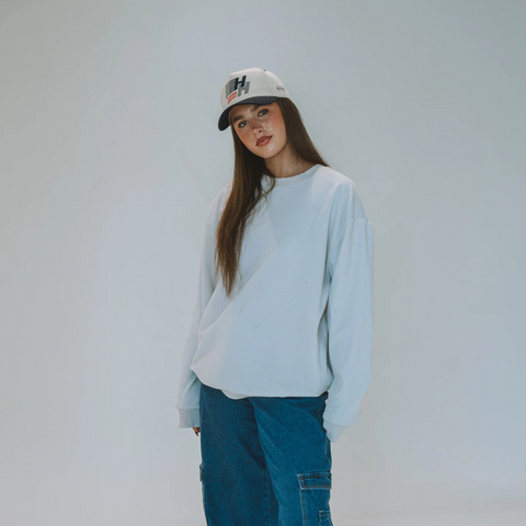 Person wearing the Huega House Legacy Hat in Navy and Natural in a coastal, weekend, or laid-back outdoor setting