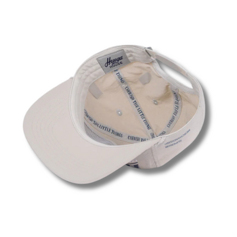 Close-up of tonal logo and durable water-resistant nylon fabric on the Huega House Tidal Hat in Grey