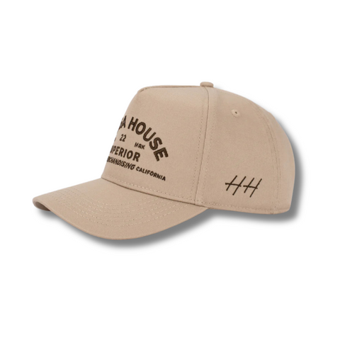 Side view of Huega House Trademark Hat in Khaki showing lightweight performance fabric, mid-profile fit, and tonal stitching
