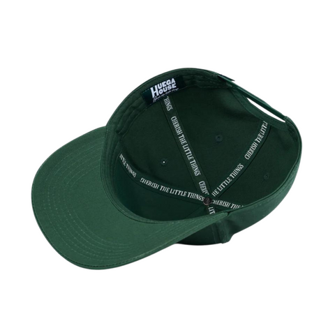 Flat lay of Huega House Vintage Swan Hat in Forest Green highlighting embroidered swan patch, tonal brim, and structured fit