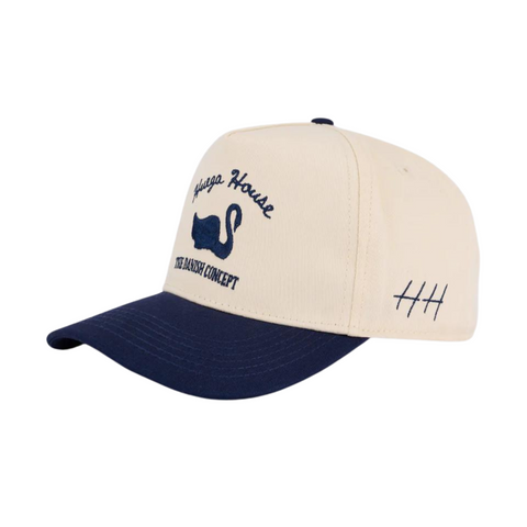 Side view of Huega House Vintage Swan Hat in Navy/Natural showing curved brim, two-tone color blocking, and breathable mesh side panels