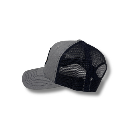 Side view of Retro Pine Hat in Heather Grey/Navy showing the contrast brim, breathable mesh back, and clean panel construction