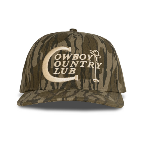 Front view of Sendero Cowboy Country Club Hat in Mossy Oak featuring a structured camo crown, curved brim, and embroidered Cowboy Country Club patch