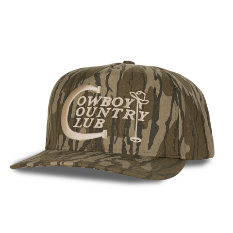 Side view of Sendero Cowboy Country Club Hat in Mossy Oak showing camo pattern, mesh back panel, and classic trucker silhouette