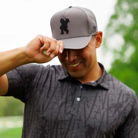 Person wearing the Waggle Sasquatch Hat in Grey on the golf course or outdoors in a casual, sporty setting
